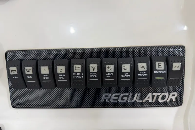 Slide: The Image of Control panel of a 2015 Regulator 23 boat with labeled switches. - 34
