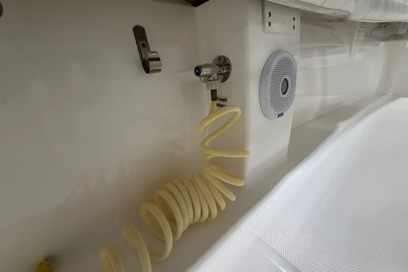 Slide: The Image of 2015 Regulator 23 boat interior with fresh water hose and speaker. - 41