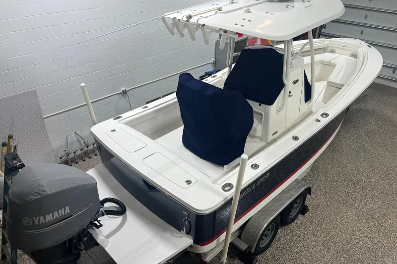 Slide: The Image of 2015 Regulator 23 boat with Yamaha engine in a garage setting. - 3