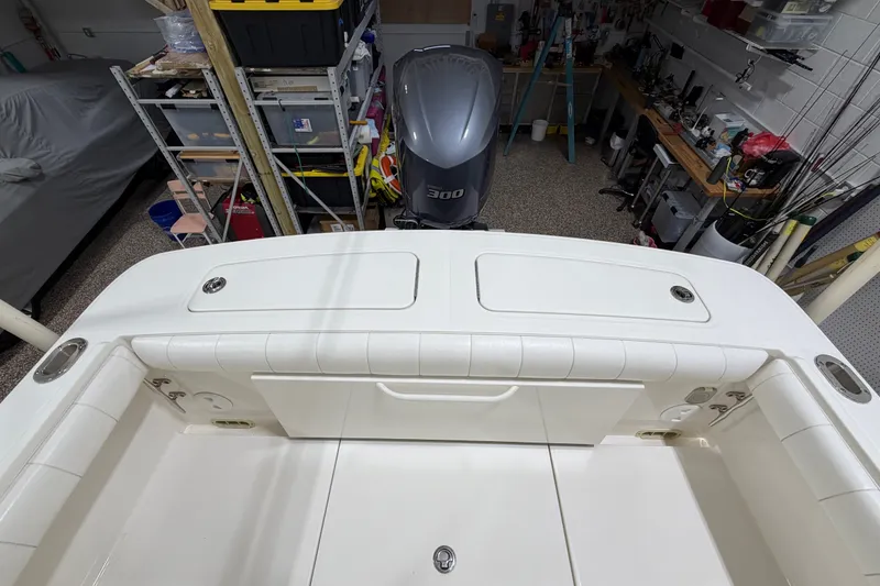 Slide: The Image of 2015 Regulator 23 boat interior with Yamaha 300 outboard in a garage setting. - 17