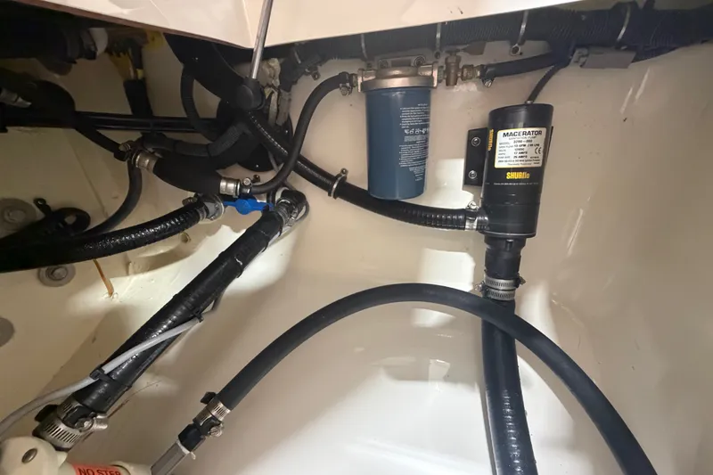 Slide: The Image of Bilge area of a 2015 Regulator 23 boat with hoses and macerator pump. - 44