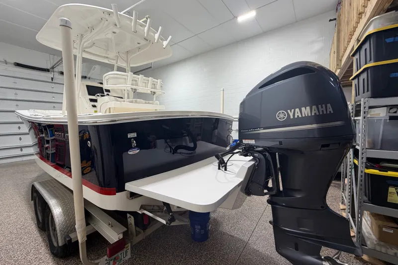 Slide: The Image of 2015 Regulator 23 boat with Yamaha outboard motor in a garage setting. - 10