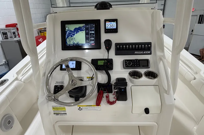 Slide: The Image of Control panel of a 2015 Regulator 23 boat with navigation and communication equipment. - 13