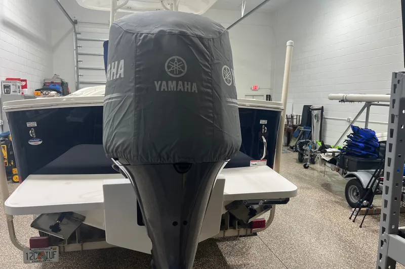 Slide: The Image of 2015 Regulator 23 boat with Yamaha engine cover in a garage setting. - 52