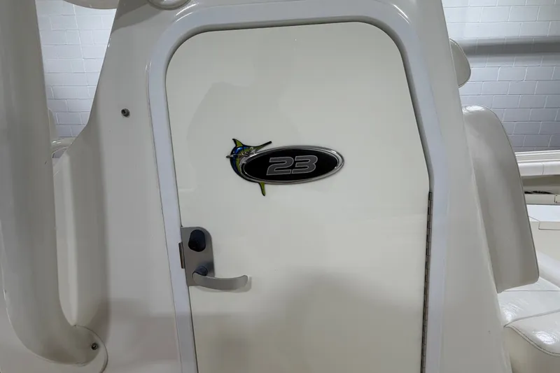 Slide: The Image of 2015 Regulator 23 boat cabin door with logo and handle. - 27