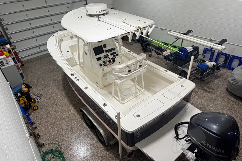Slide: The Image of 2015 Regulator 23 boat in garage, featuring Garmin equipment and Yamaha motor. - 1