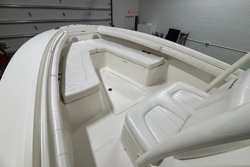 Slide: The Image of 2015 Regulator 23 boat interior with white seating and spacious layout. - 21