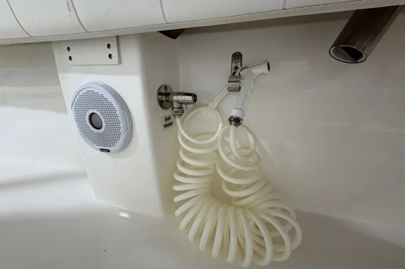 Slide: The Image of Coiled hose and speaker on 2015 Regulator 23 boat, featuring saltwater outlet. - 40