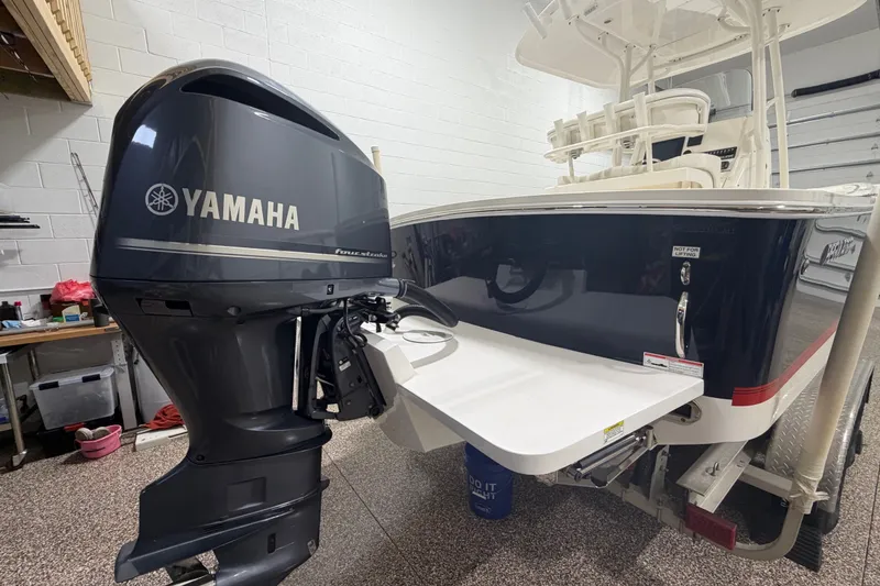 Slide: The Image of 2015 Regulator 23 boat with Yamaha outboard motor in a garage setting. - 11