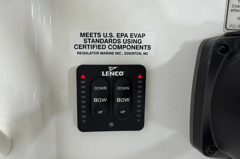 Slide: The Image of Control panel of a 2015 Regulator 23 boat with Lenco trim tab switches. - 31