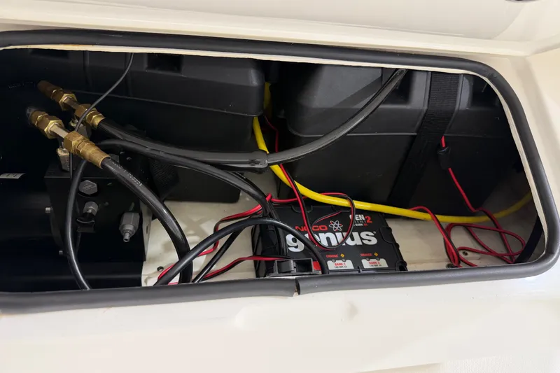 Slide: The Image of 2015 Regulator 23 boat wiring and battery compartment with Noco Genius charger. - 43