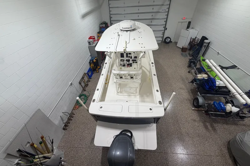 Slide: The Image of 2015 Regulator 23 boat in a garage, overhead view showing equipment and storage. - 2