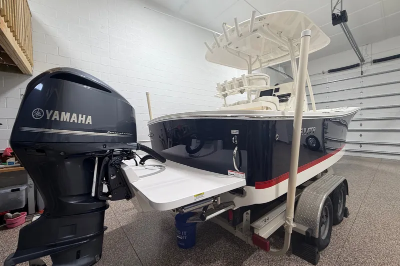 Slide: The Image of 2015 Regulator 23 boat with Yamaha outboard motor in a garage setting. - 6