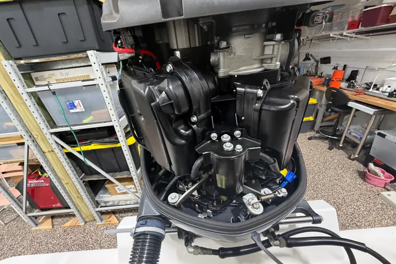 Slide: The Image of Close-up of a boat engine in a workshop with shelves in the background. - 47