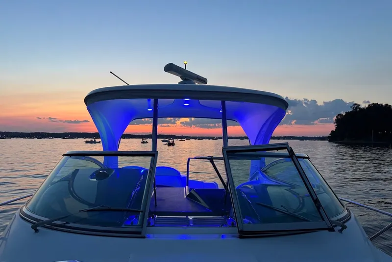 Slide: The Image of 2016 Formula 37 Performance Cruiser at sunset with blue interior lights on a calm lake. - 1