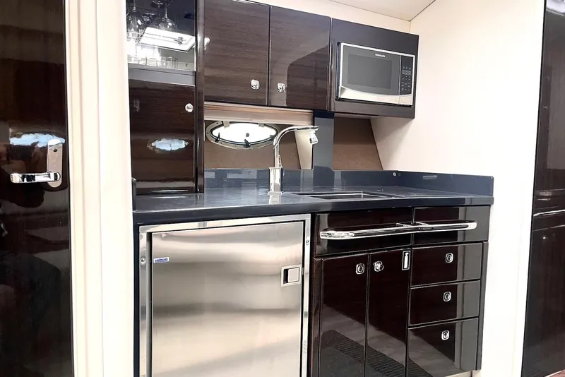 Slide: The Image of Modern kitchen in 2016 Formula 37 Performance Cruiser with sleek cabinetry and stainless steel appliances. - 7