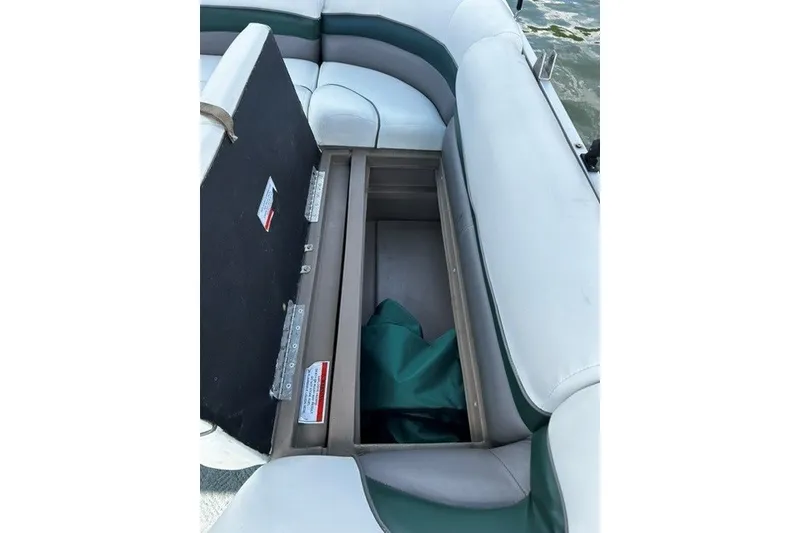Slide: The Image of Open storage compartment on 2004 Sun Tracker Party Barge 22 I/O Regency Edition boat. - 16