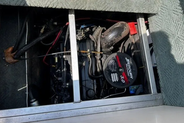 Slide: The Image of 2004 Sun Tracker Party Barge 22 I/O Regency Edition engine compartment with Mercury 3.0 motor. - 18
