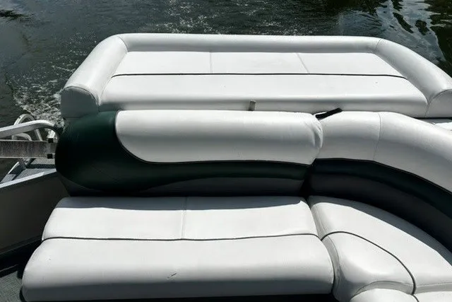 Slide: The Image of 2004 Sun Tracker Party Barge 22 I/O Regency Edition with white cushioned seating on water. - 19