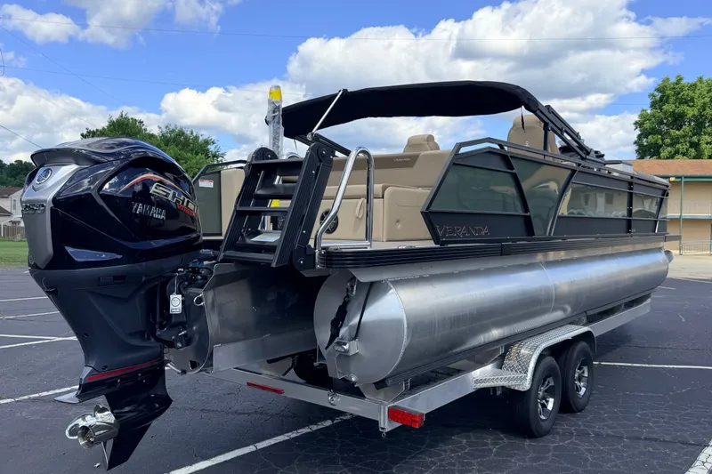 Slide: The Image of 2027 Veranda VR265VLC pontoon boat with Yamaha engine on trailer, parked outdoors. - 25