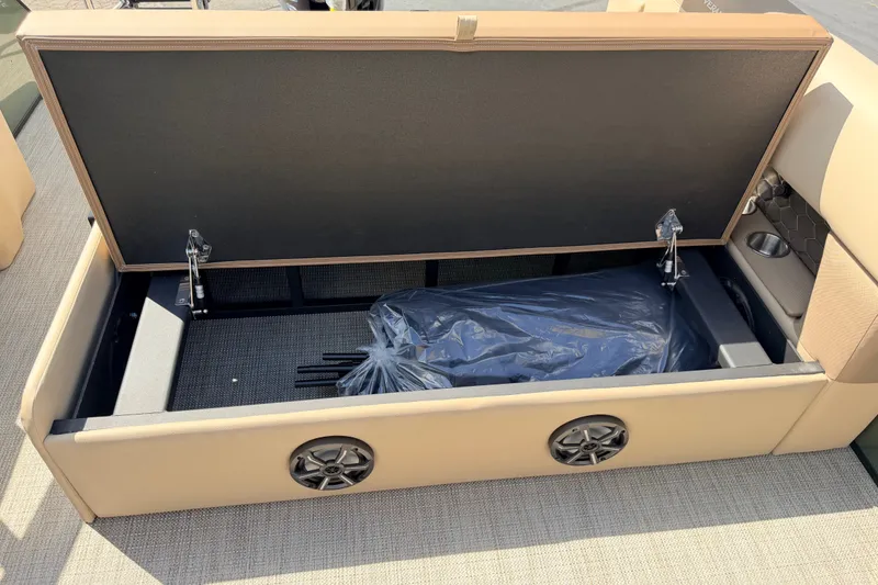 Slide: The Image of Open storage compartment in 2027 Veranda VR265VLC boat, featuring speakers and cup holders. - 20