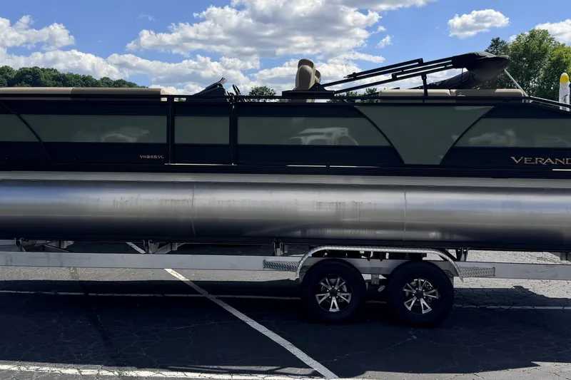 Slide: The Image of 2027 Veranda VR265VLC pontoon boat on trailer under a blue sky. - 4