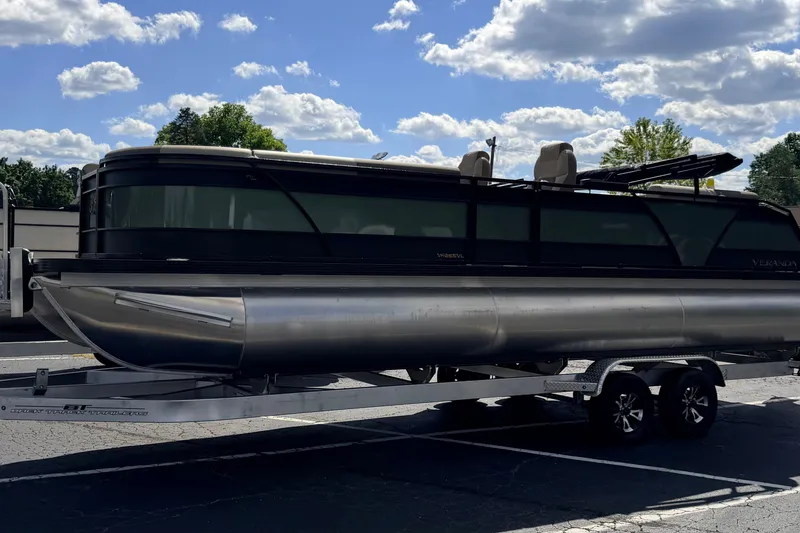 Slide: The Image of 2027 Veranda VR265VLC pontoon boat on trailer under a blue sky. - 24