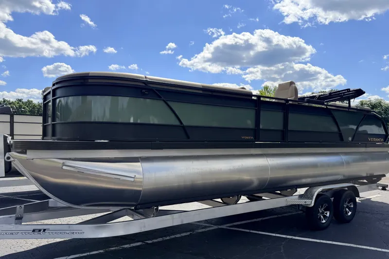 Slide: The Image of 2027 Veranda VR265VLC pontoon boat on trailer under a blue sky. - 3
