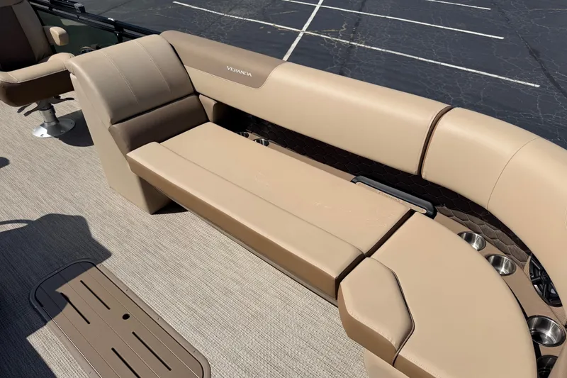 Slide: The Image of 2027 Veranda VR265VLC boat interior with beige seating and cup holders. - 13