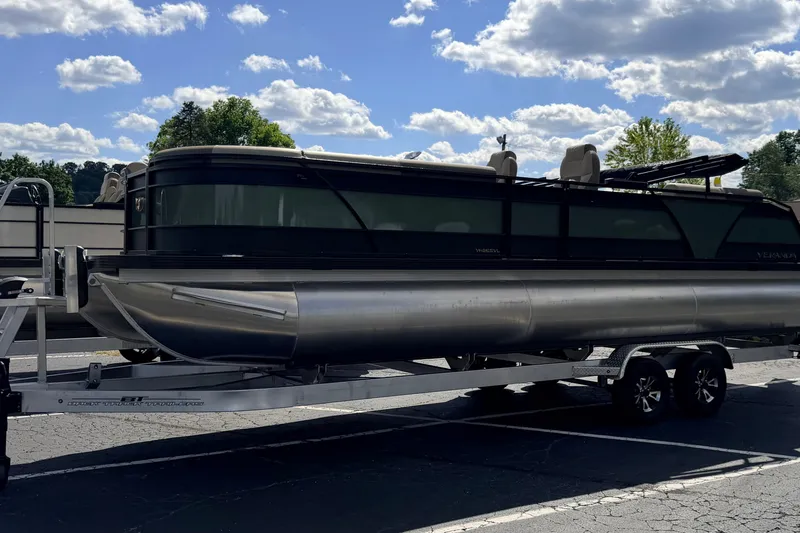 Slide: The Image of 2027 Veranda VR265VLC pontoon boat on trailer under a partly cloudy sky. - 23