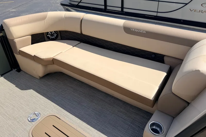 Slide: The Image of Luxurious seating on 2027 Veranda VR265VLC boat, featuring beige upholstery and integrated speaker. - 14