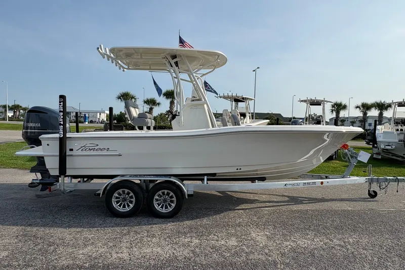 Slide: The Image of 2027 Pioneer 220 Bay Sport boat on trailer, side view, outdoors. - 3