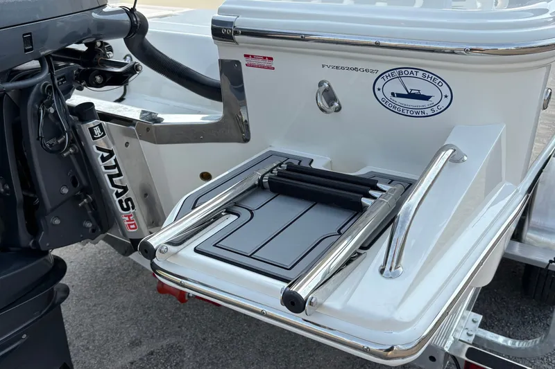 Slide: The Image of 2027 Pioneer 220 Bay Sport boat with Atlas HD motor and swim platform ladder. - 8