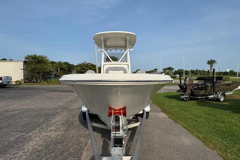Slide: The Image of 2027 Pioneer 220 Bay Sport boat on trailer, parked outdoors under clear sky. - 5