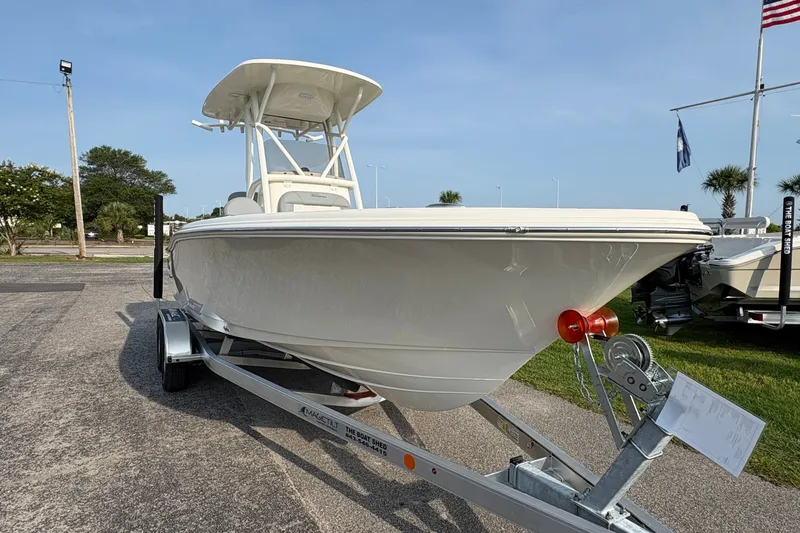 Slide: The Image of 2027 Pioneer 220 Bay Sport boat on trailer, displayed outdoors under clear sky. - 4