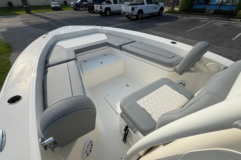 Slide: The Image of 2027 Pioneer 220 Bay Sport boat interior with cushioned seating and storage compartments. - 28