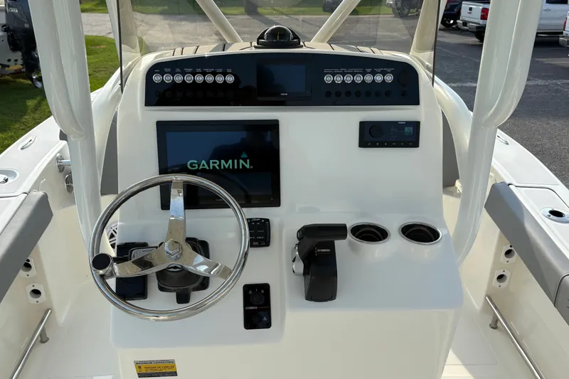 Slide: The Image of 2027 Pioneer 220 Bay Sport boat dashboard with Garmin display and Yamaha controls. - 20