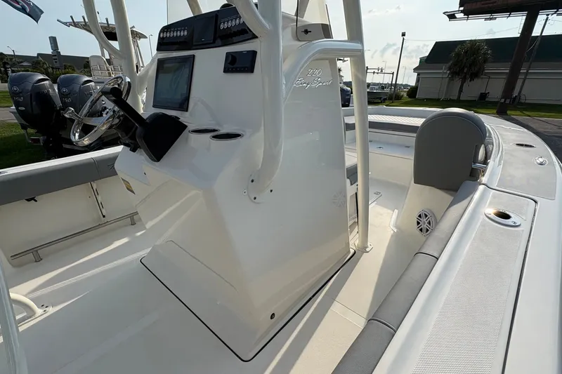 Slide: The Image of 2027 Pioneer 220 Bay Sport boat interior with steering console and seating. - 25