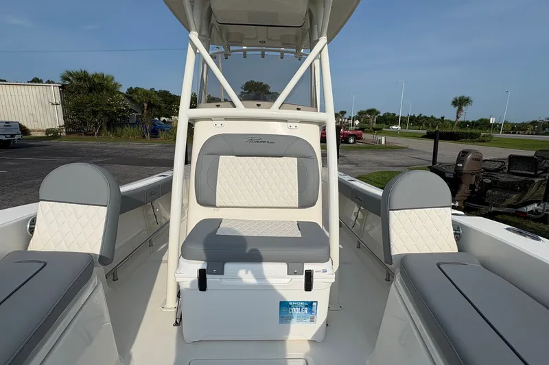 Slide: The Image of 2027 Pioneer 220 Bay Sport boat interior with cushioned seating and storage. - 30