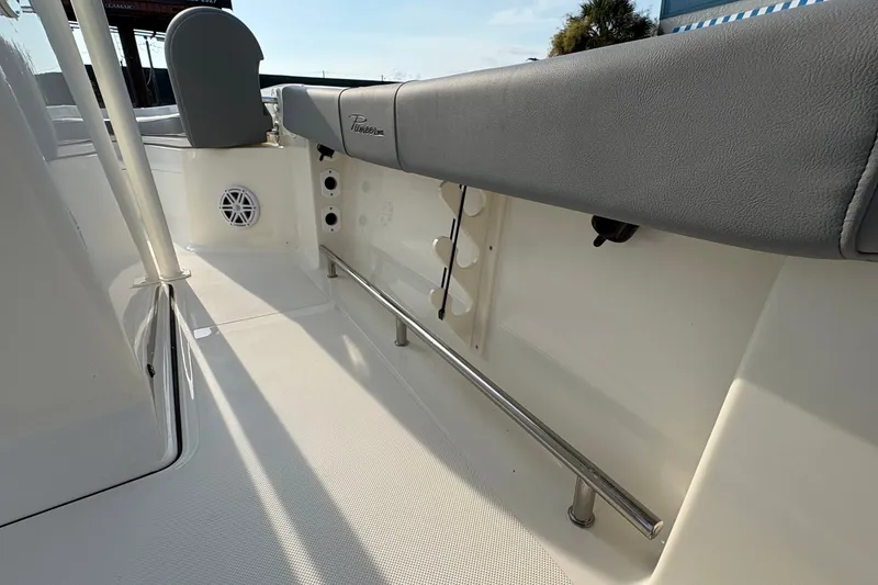 Slide: The Image of 2027 Pioneer 220 Bay Sport boat interior with seating and speaker detail. - 23