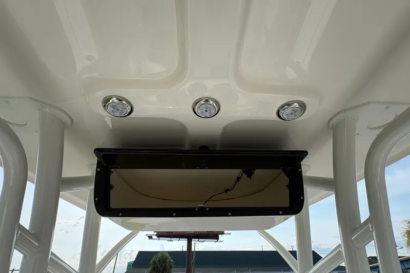 Slide: The Image of 2027 Pioneer 220 Bay Sport boat interior ceiling with built-in lights and storage compartment. - 19