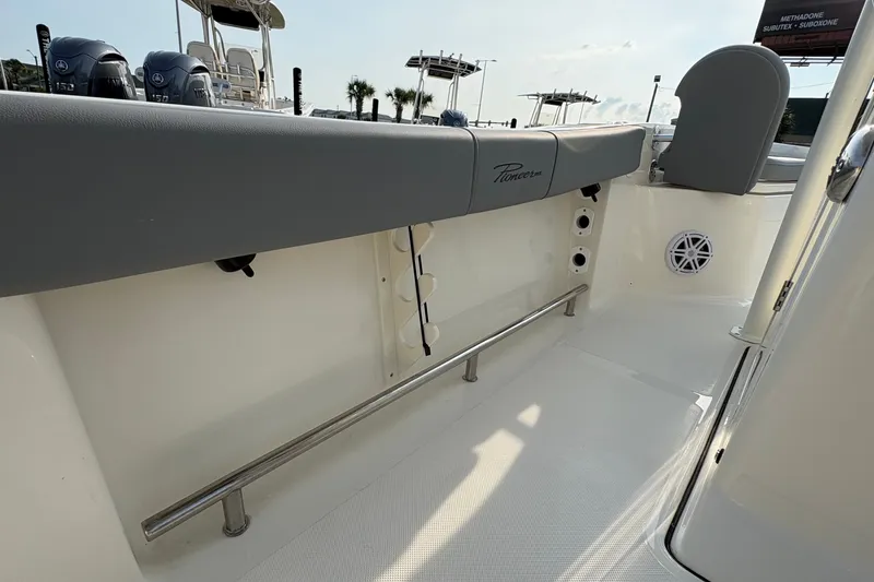 Slide: The Image of 2027 Pioneer 220 Bay Sport boat interior with seating and railing. - 24