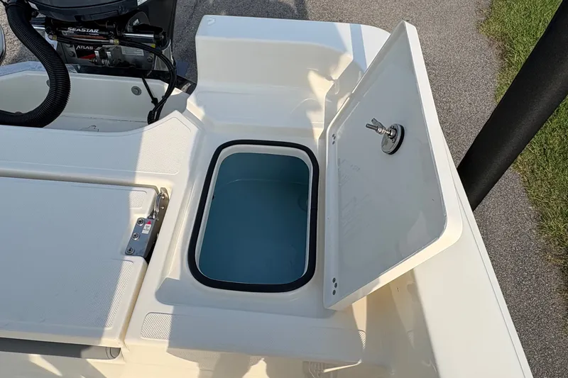 Slide: The Image of Open storage compartment on 2027 Pioneer 220 Bay Sport boat, featuring a sleek design. - 14