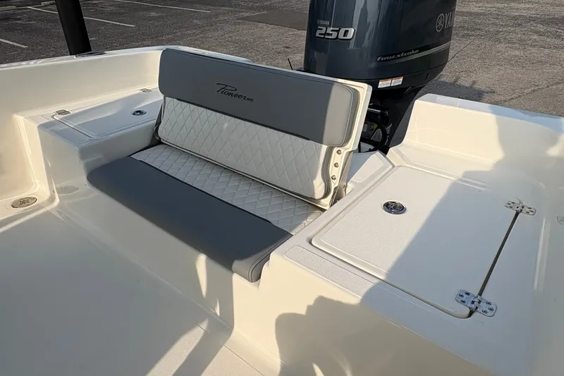 Slide: The Image of 2027 Pioneer 220 Bay Sport boat interior with Yamaha 250 engine, featuring cushioned seating. - 11