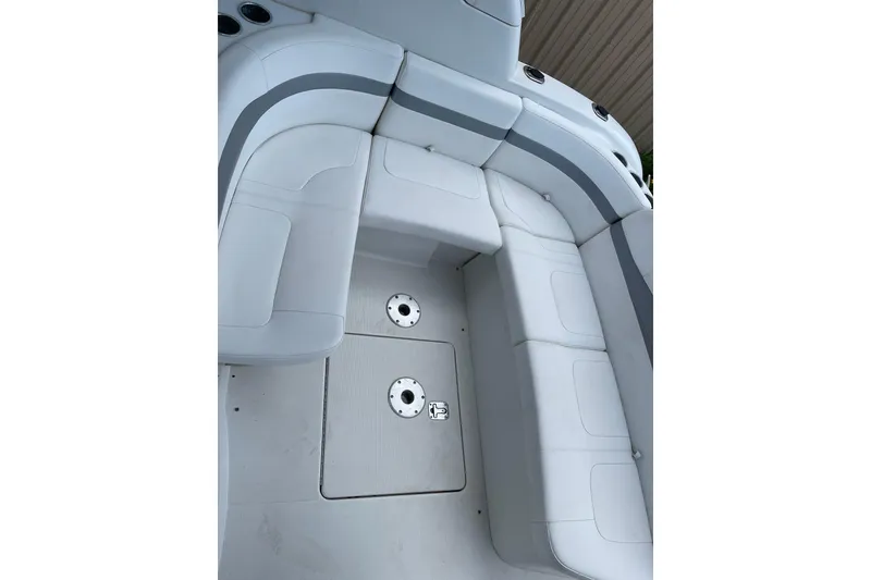 Slide: The Image of 2004 Formula 34 Performance Cruiser interior seating area with white upholstery and storage compartments. - 6