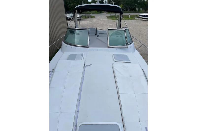 Slide: The Image of 2004 Formula 34 Performance Cruiser boat with spacious deck and windshield, docked outdoors. - 25