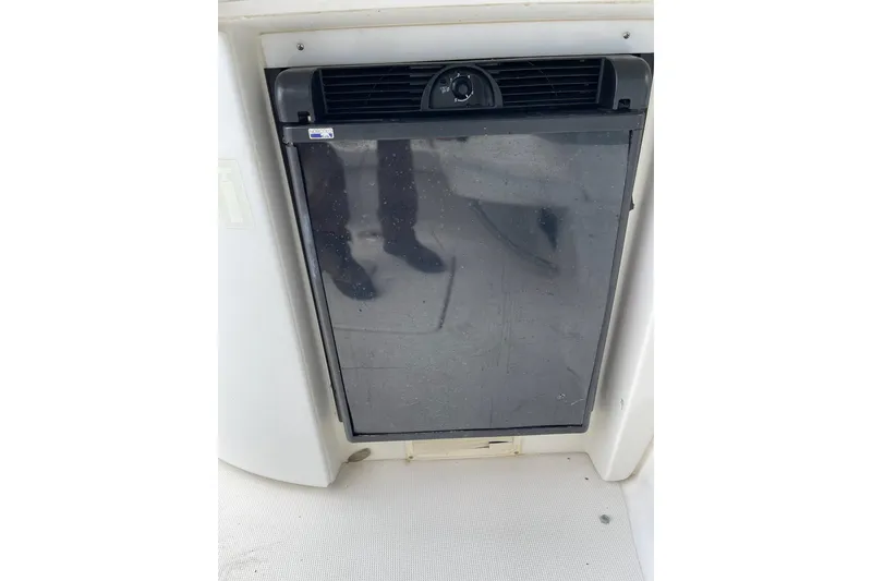 Slide: The Image of 2004 Formula 34 Performance Cruiser refrigerator, black door, compact design. - 13