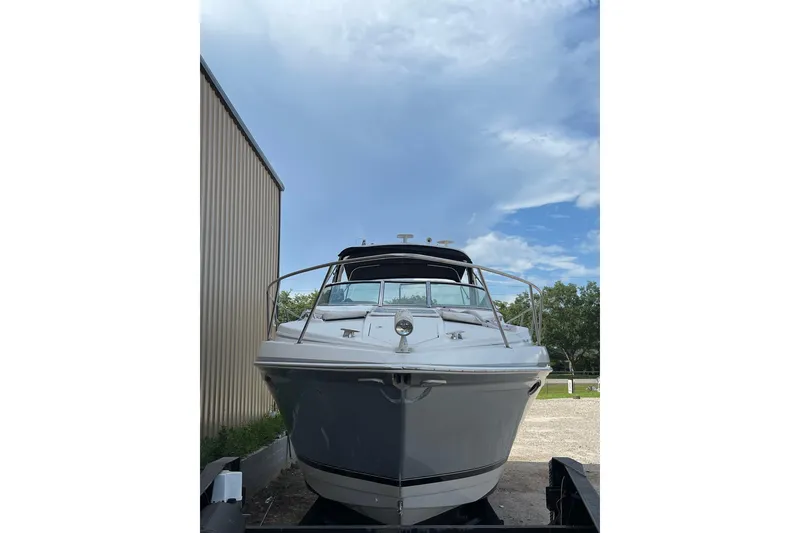 Slide: The Image of 2004 Formula 34 Performance Cruiser boat docked under a clear blue sky. - 3