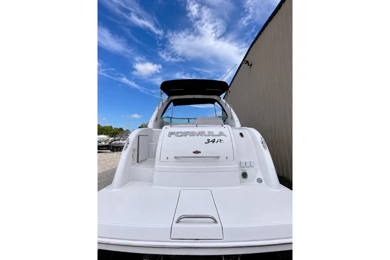 Slide: The Image of 2004 Formula 34 Performance Cruiser boat, rear view under a clear blue sky. - 4