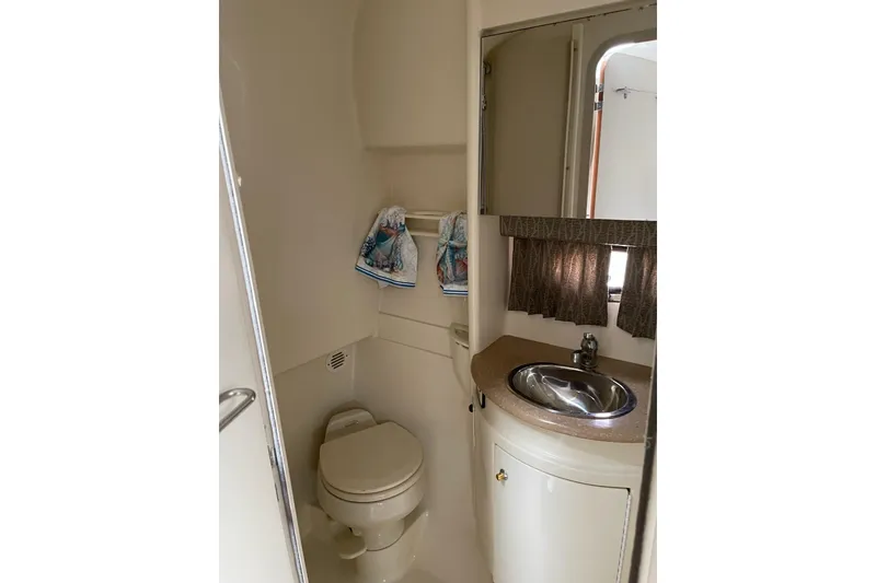Slide: The Image of 2004 Formula 34 Performance Cruiser bathroom with sink, toilet, and storage cabinet. - 20
